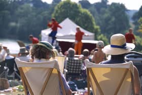 View from behind two visitors seated in deckchairs as part of the audience at the Illyria Theatre Company's production of Ali Baba & the Forty Thieves at Dudmaston. M.R.