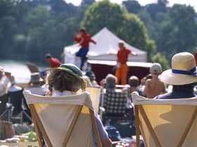 View from behind two visitors seated in deckchairs as part of the audience at the Illyria Theatre Company's production of Ali Baba & the Forty Thieves at Dudmaston. M.R.