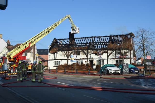 Firefighters tackle the thatched roof fire at The Shambles pub in Lutterworth