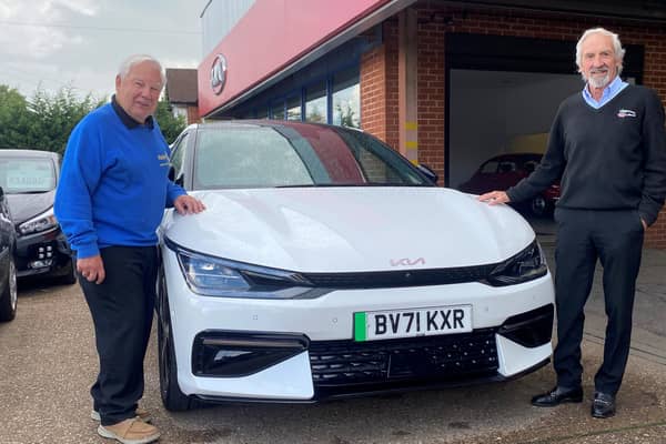 Barry Andrews (left), chairman of Leamington Rotary Club’s fundraising committee, with Warwick Kia managing director David Derbyshire beside a Kia Electric