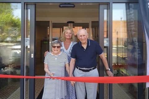 New residents Alison Partridge and John Ackerman, cutting the ribbon to open the new care home. Stood behind them is Phillippa Cook, general manager of the home. Photo supplied