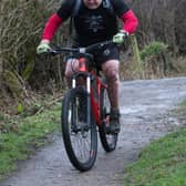 Mountain bike challenge carrying 25 lb expedition backpack.