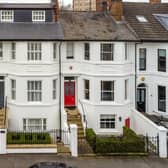 The property (house with dark grey door) has been listed with a guide price of £1,200,000.