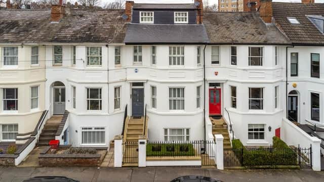The property (house with dark grey door) has been listed with a guide price of £1,200,000.