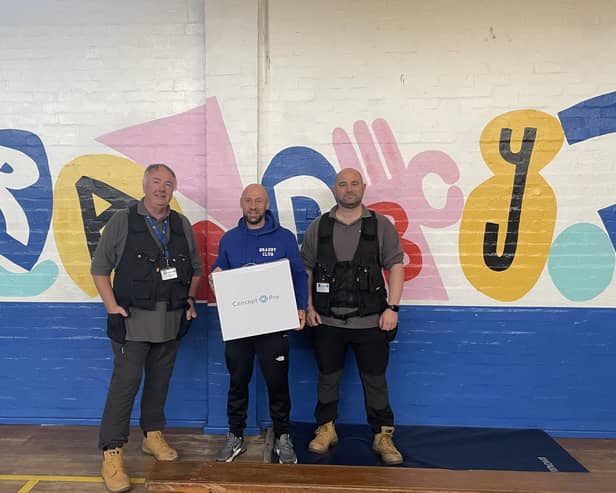 Bradby Club Leader John Robertson with ADT engineers Mark Clifford and Dean Aston.