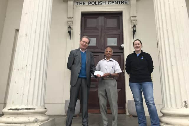 Stas Librowski and Sophie Powers of the Leamington Polish Centre with Ram Prinjha (centre) who is handing over the cheque for £700 raised from the plant and flower sale. Picture submitted.