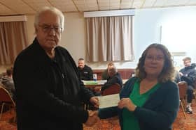 Leamington and District Sunday Football League general & fixture secretary and BCFA representative Steve Falp hands over the cheque for £1,000 to Evelyn's Gift founder Helen Smith. Picture supplied.
