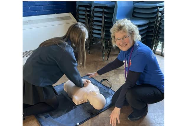 Seringa Dudley, a Trustee of Kenilworth HeartSafe and a lead trainer on the day, showing a pupil CPR. Photo supplied