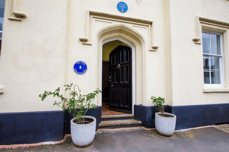 The front of the property with the newly installed blue plaque to the left of the front door.