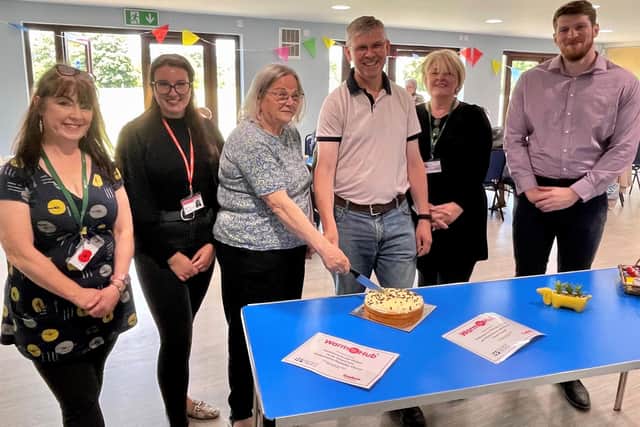 Cutting the cake: Cllr Anne Prior, Wellesbourne and Walton Parish Council Chair (centre left) and Graeme Russell, Wellesbourne Methodist Church and Community Missioner (centre right), with Susan Greenway, WRCC Mobile Warm Hub Project Co-ordinator (far left), Jazzmine Bryce, Cadent Gas Project Co-ordinator, Anne White, WRCC Warm Hubs Project Co-ordinator (second right) and Edward Allard, Cadent Social Programmes Manager (far right). Photo supplied