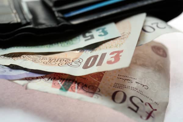 Stock picture Fifty, Twenty, Ten, and Five pound notes in a wallet.