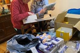 Volunteers box up items for people in Romania.