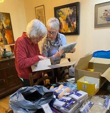 Volunteers box up items for people in Romania.