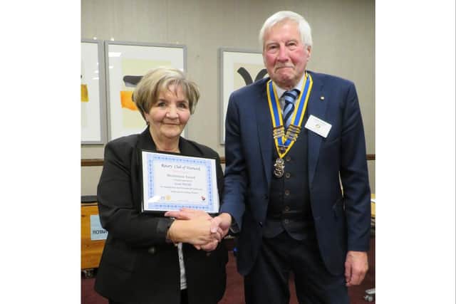 Sue Melville being presented her award by Warwick Rotary president Alan Bailey. Photo supplied