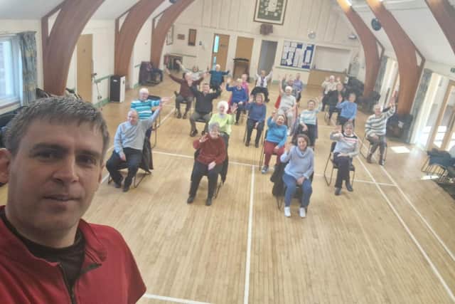 Instructor Steve Blake leads a seated exercise class at Harbury Village Hall. Photo supplied