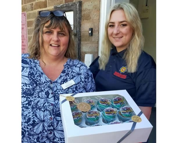 One of the team members from Leycester House handing out cupcakes to one of the emergency workers at Leamington fire station. Photo supplied