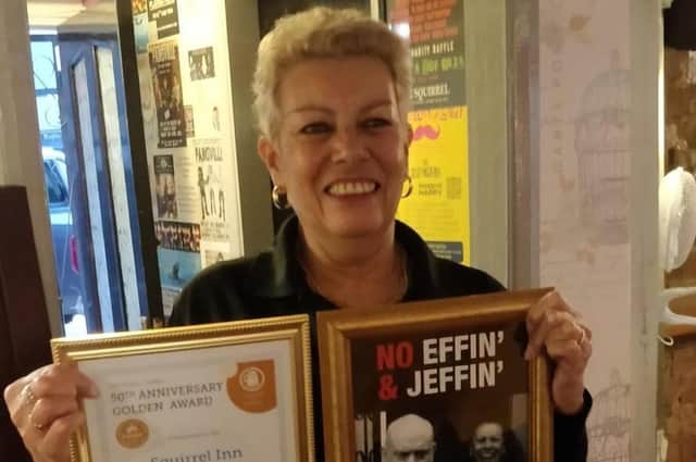Sue Garaghty with the Squirrel's special CAMRA gold award and a message to customers...