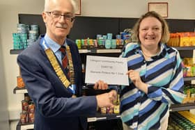 Joe Murphy, Chairman of Warwick Probus No 1 Club presents Faye Abbott of the Lillington Community Pantry with the grand total of £2407 raised.