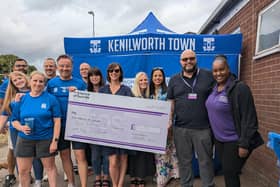 Members of the Fab 55 team present the cheque for the money they raised from their Two Castles Run efforts in June. Picture supplied.