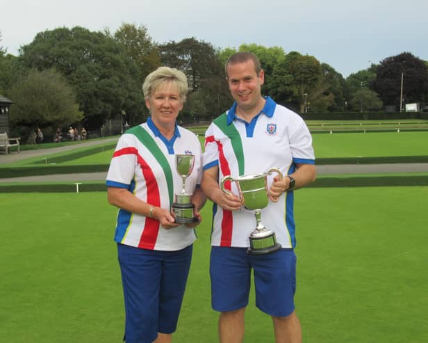 2023 Ladies’ and Men’s Singles Champions, Anita Cowdrill (left) and Graham White (right), with their trophies.