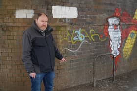 Cllr Will Roberts highlights the pigeon problem at the bridge over the junction of Bath Street, High Street and Clemens Street. Photo by Warwick District Council