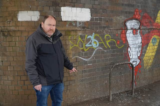 Cllr Will Roberts highlights the pigeon problem at the bridge over the junction of Bath Street, High Street and Clemens Street. Photo by Warwick District Council