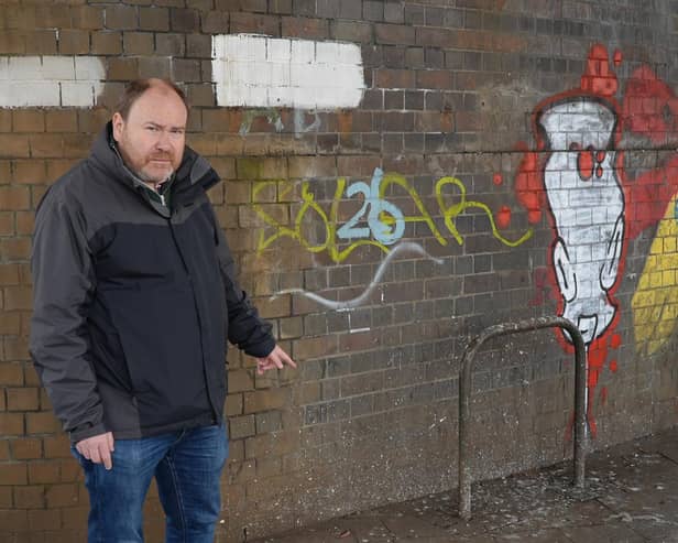 Cllr Will Roberts highlights the pigeon problem at the bridge over the junction of Bath Street, High Street and Clemens Street. Photo by Warwick District Council