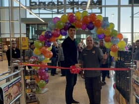 Commonwealth Games gold medallist Lewis Williams cutting the ribbon at Morrisons in Leamington with Justin Cole. Photo suppled