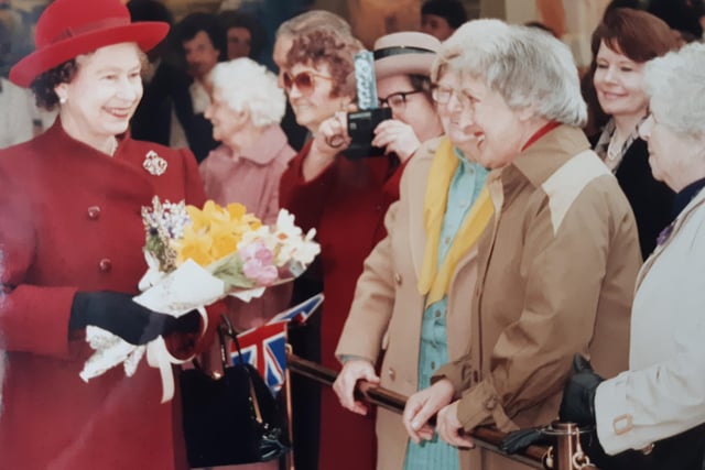 The Queen stops to talk to members of the public at the Royal Priors shopping centre.