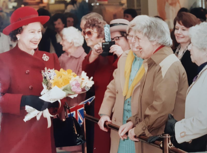 The Queen stops to talk to members of the public at the Royal Priors shopping centre.
