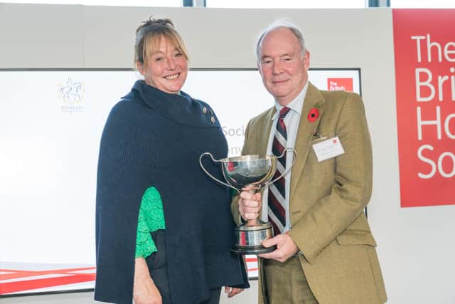 Philip Seccombe, Chair of Warwickshire Road Safety Partnership receiving the Tarquin Trophy for Equestrian Safety from The BHS Ambassador Lizzie Greenwood-Hughes. Photo courtesy of Warwickshire Police