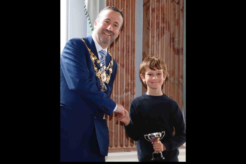 The Mayor of Warwick, Councillor Oliver Jacques, presenting the eight to 11 year old section winner Daniel Hough his trophy. Photo supplied
