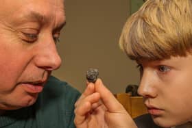 Paul Butler and his son Nathan with suspected meteorite rock