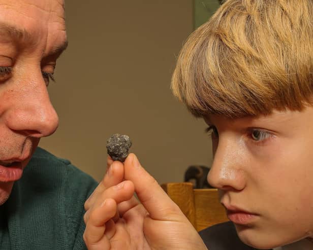 Paul Butler and his son Nathan with suspected meteorite rock