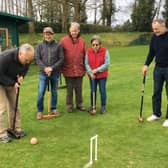 Nigel Pigdon scores the first hoop of the season watched by fellow Association Croquet players.