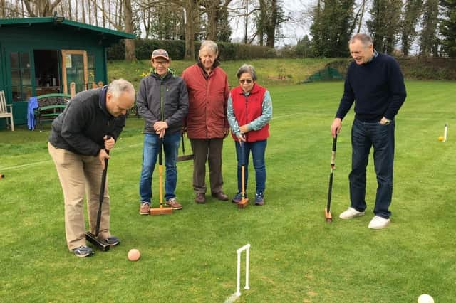 Nigel Pigdon scores the first hoop of the season watched by fellow Association Croquet players.