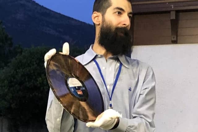 Jesus I. Agnew, holding up a copper-plated record made using the ‘DMM’ method.