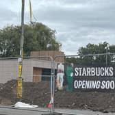 It's been a long time since permission was given for the building and for Starbucks signs to be put on it - but a new banner suggests work is back on track.