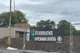 It's been a long time since permission was given for the building and for Starbucks signs to be put on it - but a new banner suggests work is back on track.