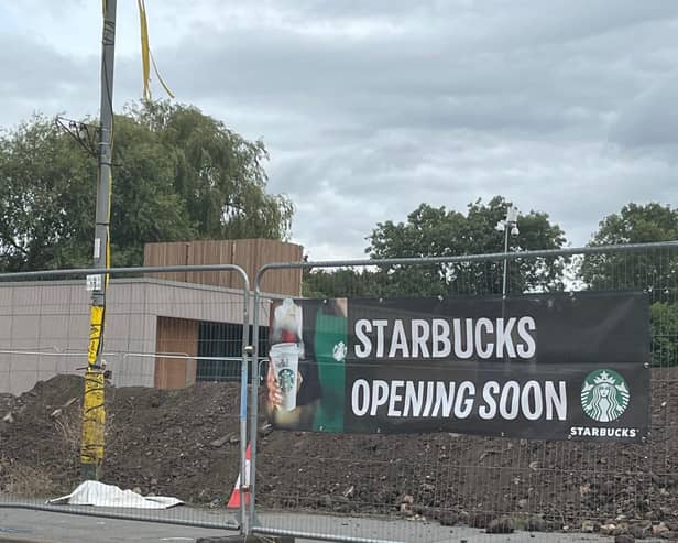 It's been a long time since permission was given for the building and for Starbucks signs to be put on it - but a new banner suggests work is back on track.