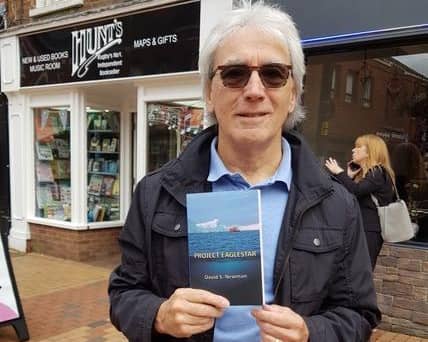 David S Newman with his book.