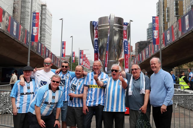 Fans pose for a photo as they arrive outside the stadium prior to the Sky Bet League Two Play Off Final between Coventry City and Exeter City at Wembley Stadium on May 28, 2018