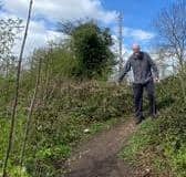 Dave Steele, of FoRGE, demonstrates the difficulty of using one of the current and unofficial access paths to the Grand Union Canal towpath at Radford Semele. Picture supplied.