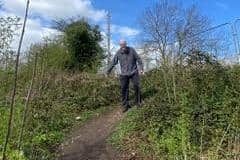 Dave Steele, of FoRGE, demonstrates the difficulty of using one of the current and unofficial access paths to the Grand Union Canal towpath at Radford Semele. Picture supplied.