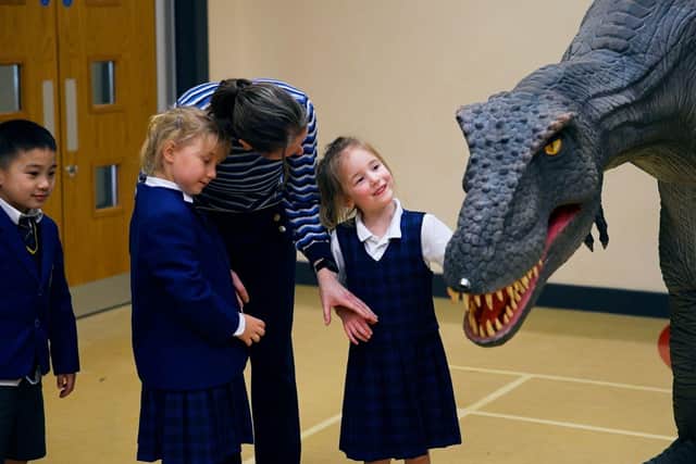 Reggie the animatronic T-Rex with pupils at one of the Giant Journeys workshops.
