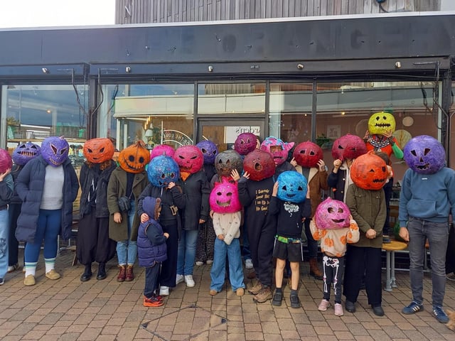 Some of the people taking part in the event wearing Andrew's handmade pumpkin heads.