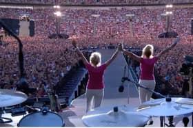 Barbara Graham and her sister Janette Fairclough take to the stage in front of 90,000 people to announce Coldplay at the band's recent concert at Wembley Stadium. Picture supplied.