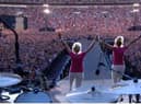 Barbara Graham and her sister Janette Fairclough take to the stage in front of 90,000 people to announce Coldplay at the band's recent concert at Wembley Stadium. Picture supplied.