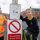 Luke McGrath, Assistant Site Manager, with winner Joshua Gibbs and his winning poster displayed in the Bramcote Grange development.