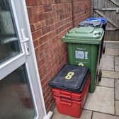 Warwick district household waste bins and the old red recycling collection boxes. Stock image.